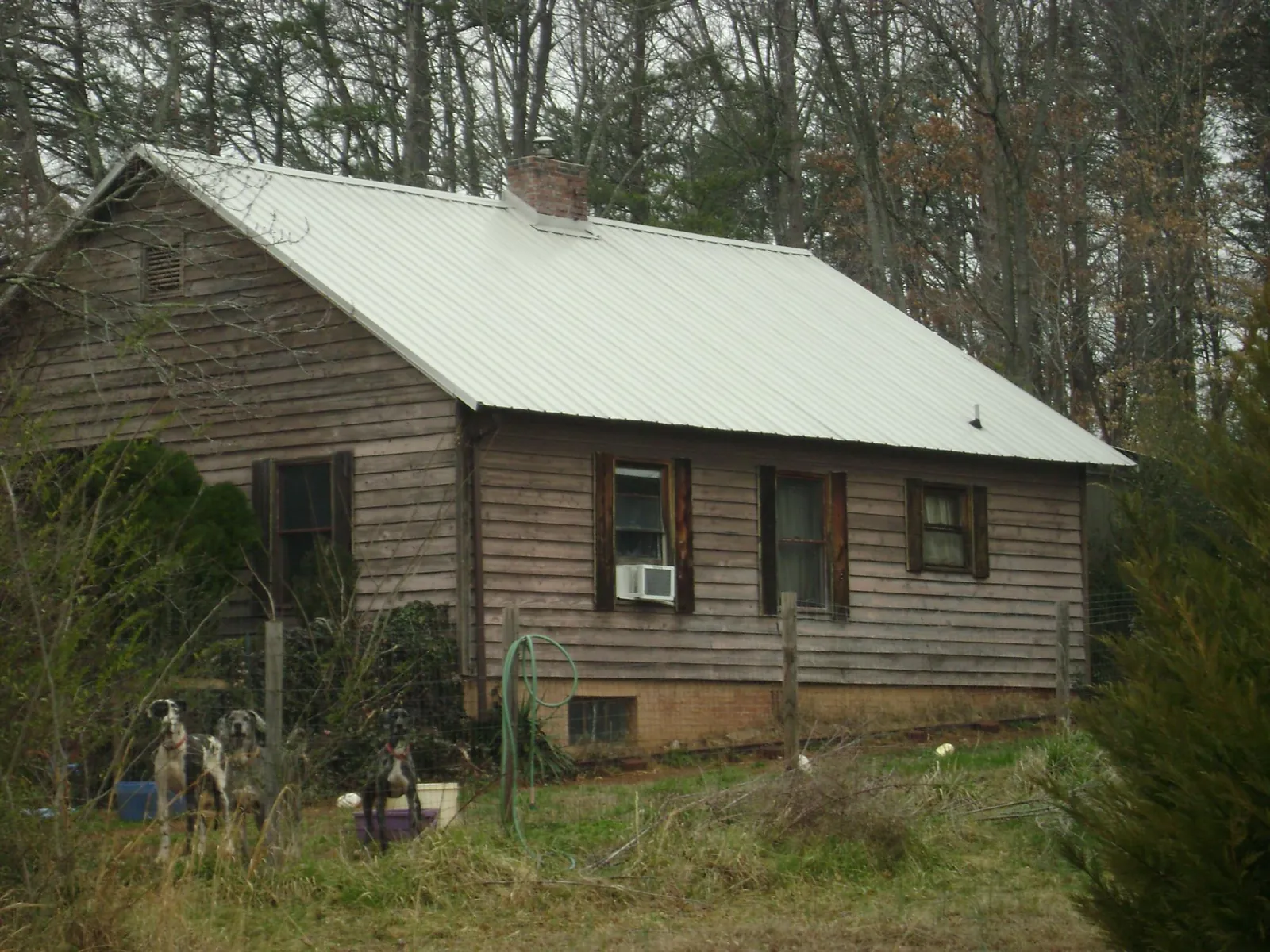 White metal roof on an old wood sided farmhouse, from a Metal Roof Installation job in Piketon